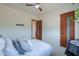 Bright bedroom with neutral colors, a ceiling fan, and modern wood doors at 15574 N Brielles Way, Maricopa, AZ 85139