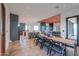 Bright dining area featuring a long wooden table and modern decor at 15574 N Brielles Way, Maricopa, AZ 85139