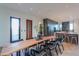 Contemporary dining room with wood table and chairs, with kitchen and backyard views at 15574 N Brielles Way, Maricopa, AZ 85139