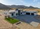 Aerial view of modern home with desert landscaping and mountain views, highlighting architectural style at 15574 N Brielles Way, Maricopa, AZ 85139