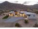 Aerial view of contemporary home with desert landscaping, mountain backdrop, and modern design elements at 15574 N Brielles Way, Maricopa, AZ 85139