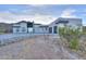 Modern desert home featuring a sleek design and a desert landscape for curb appeal at 15574 N Brielles Way, Maricopa, AZ 85139