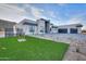 Contemporary home featuring desert landscaping, stone accents, and an attached two car garage at 15574 N Brielles Way, Maricopa, AZ 85139