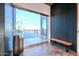 Modern foyer featuring glass doors, a wood accent wall, and concrete floors at 15574 N Brielles Way, Maricopa, AZ 85139