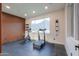 Home gym with exercise equipment, natural light, and wood wall at 15574 N Brielles Way, Maricopa, AZ 85139