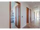 Hallway with natural light and modern wood doors leading to rooms in the home at 15574 N Brielles Way, Maricopa, AZ 85139