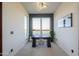 Bright home office with a large window, modern lighting, and a minimalist desk setup for productive work at 15574 N Brielles Way, Maricopa, AZ 85139