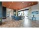 Stylish living room with a stone wall, fireplace and expansive backyard view at 15574 N Brielles Way, Maricopa, AZ 85139