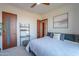 Bright main bedroom with neutral colors, a ceiling fan, and an open doorway at 15574 N Brielles Way, Maricopa, AZ 85139