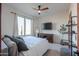 Bright main bedroom with a ceiling fan and neutral colors, allowing the outdoors in through large windows at 15574 N Brielles Way, Maricopa, AZ 85139