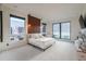 Serene bedroom with calming natural light, wood accent wall, neutral tones, and a view of the outdoor patio at 15574 N Brielles Way, Maricopa, AZ 85139