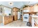 Modern kitchen featuring light wood cabinets, granite countertops, and tile flooring for easy maintenance at 17200 W Bell Rd # 866, Surprise, AZ 85374