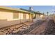 Backyard with concrete patio, rock detail, and a view of the home's exterior at 1721 W Weldon Ave, Phoenix, AZ 85015