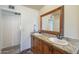 Bathroom vanity featuring granite countertops, dual sinks, and wooden cabinets offering plenty of storage at 1721 W Weldon Ave, Phoenix, AZ 85015