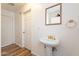 Bathroom vanity and mirror with access to other rooms via white paneled doors at 1721 W Weldon Ave, Phoenix, AZ 85015