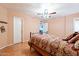 Comfortable bedroom showcasing a decorative bed, hardwood floors, and a view into another room at 1721 W Weldon Ave, Phoenix, AZ 85015