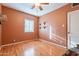 Bedroom featuring hardwood floors, a ceiling fan, and a window with natural light at 1721 W Weldon Ave, Phoenix, AZ 85015