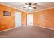 Bedroom with textured walls, ceiling fan, and convenient access through two white paneled doors at 1721 W Weldon Ave, Phoenix, AZ 85015