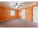 Bedroom featuring vibrant textured walls, ceiling fan, window, and convenient double door access at 1721 W Weldon Ave, Phoenix, AZ 85015