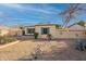 Southwestern desert landscaping surrounds this single story home with painted exterior walls at 1721 W Weldon Ave, Phoenix, AZ 85015