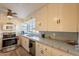 A view of the vintage kitchen featuring stainless steel appliances, a microwave, and tile countertops at 1721 W Weldon Ave, Phoenix, AZ 85015