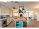 Bright and airy kitchen with a large island, pot rack, and stainless steel appliances at 1721 W Weldon Ave, Phoenix, AZ 85015