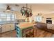 Spacious kitchen featuring a center island, tiled countertops, and open living area at 1721 W Weldon Ave, Phoenix, AZ 85015