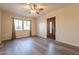 Bright living room featuring sleek laminate flooring, a ceiling fan, and lots of natural light at 1721 W Weldon Ave, Phoenix, AZ 85015