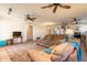 This living room has neutral paint, ceiling fans, an opening to the kitchen, and beautiful wood flooring at 1721 W Weldon Ave, Phoenix, AZ 85015