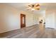 Living room with wood-look floors, front door, a ceiling fan, and built-in shelves at 1721 W Weldon Ave, Phoenix, AZ 85015