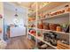 Well-stocked pantry with ample shelving and storage space, adjacent to laundry area at 1721 W Weldon Ave, Phoenix, AZ 85015