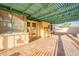 Covered patio featuring tiled floor and a green pergola, perfect for outdoor enjoyment at 1721 W Weldon Ave, Phoenix, AZ 85015