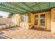 Covered patio with tiled floors, a seating bench and a view of the pool at 1721 W Weldon Ave, Phoenix, AZ 85015