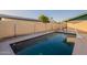 Backyard pool surrounded by fence with concrete perimeter and blue-tile accent at 1721 W Weldon Ave, Phoenix, AZ 85015