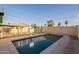 Backyard pool with diving board and fence surrounding the in-ground pool at 1721 W Weldon Ave, Phoenix, AZ 85015