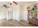 Functional room featuring two ceiling fans, plank flooring, and ample storage with built-in shelving at 1721 W Weldon Ave, Phoenix, AZ 85015