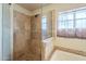 A walk-in shower with a glass enclosure and tiled walls at 1721 W Weldon Ave, Phoenix, AZ 85015