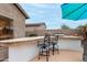 Enjoy outdoor dining at the built-in bar with grill, perfect for entertaining guests, with plenty of space to relax and unwind at 17751 W Desert View Ln, Goodyear, AZ 85338