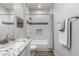 Beautiful bathroom featuring a granite counter, modern fixtures, and tiled shower and bath at 17751 W Desert View Ln, Goodyear, AZ 85338