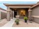 Charming front porch featuring stone columns, xeriscaping, and a secure front entry, welcoming you to your new home at 17751 W Desert View Ln, Goodyear, AZ 85338