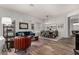 Inviting living room and dining room with modern chandelier, wood floors, and comfortable seating arrangement at 17751 W Desert View Ln, Goodyear, AZ 85338