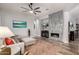 Living room featuring a modern fireplace, tile accent wall, and comfortable seating at 17751 W Desert View Ln, Goodyear, AZ 85338