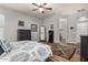 Spacious main bedroom with wood floors, a ceiling fan, and ensuite bathroom at 17751 W Desert View Ln, Goodyear, AZ 85338