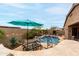 Resort-style pool area with a lush tropical landscape, a built in bar and comfortable seating at 17751 W Desert View Ln, Goodyear, AZ 85338