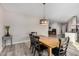 Open dining area offering a spacious layout with views of adjacent living spaces, featuring a wooden table and modern light at 1841 E Clarendon Ave, Phoenix, AZ 85016