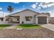 Well-maintained exterior with a modern design, a garage, nice stone landscaping, and inviting curb appeal at 1841 E Clarendon Ave, Phoenix, AZ 85016