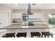 Bright kitchen boasts a large center island with seating and modern stainless steel hood and white cabinets at 1841 E Clarendon Ave, Phoenix, AZ 85016