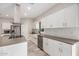 Modern kitchen with stainless steel appliances, white cabinets, gray countertops and backsplash at 1841 E Clarendon Ave, Phoenix, AZ 85016