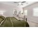 Serene main bedroom with a ceiling fan, view to the ensuite bathroom, and ample natural light at 1841 E Clarendon Ave, Phoenix, AZ 85016