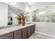 Bright bathroom boasts a spacious vanity with double sinks and an elegant, glass-enclosed shower at 18938 W Luke Ave, Litchfield Park, AZ 85340